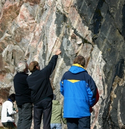 John Ramsay (centre, left) and John Myers discuss deformation and intrusion histories in the Laxford Shear Zone. (photo by Rob Butler).