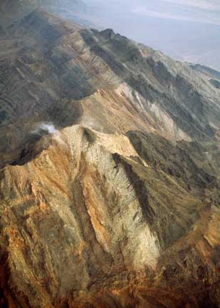 Ordovician on edge: tilted Paleozoic rocks of the Funeral Mountains above Furnace Creek in the Death Valley region of California. The black layer is the Ordovician Eureka Quartzite. Image courtesy & © Michael Collier.